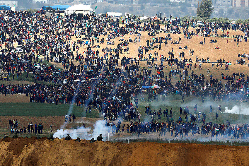 Soldados israelíes disparan gas lacrimógeno desde el lado israelí de la frontera entre Israel y Gaza, mientras los palestinos protestan desde la frontera de Gaza, el 30 de marzo de 2018. © REUTERS/Amir Cohen