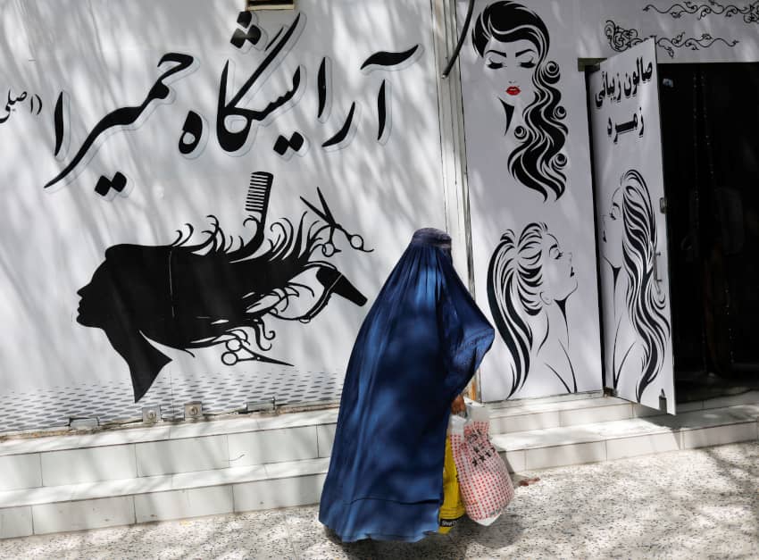 Una mujer afgana pasea por delante de un salón de belleza. El cierre de estos centros es otra de las prohibiciones impuestas por los talibanes