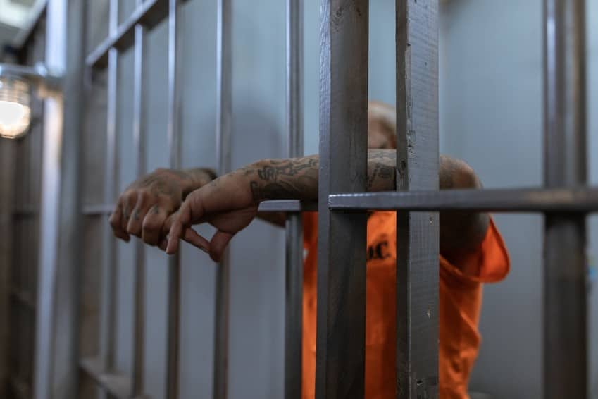 Un preso condenado tras las barras de una prisión. Historia de la pena de muerte
