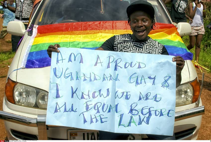 Un hombre sostiene con orgullo una bandera arcoíris en Kampala, Uganda, en defensa de los derechos LGBTQ+